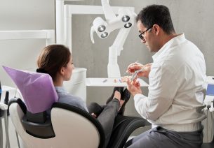 Dentist in surgery with client